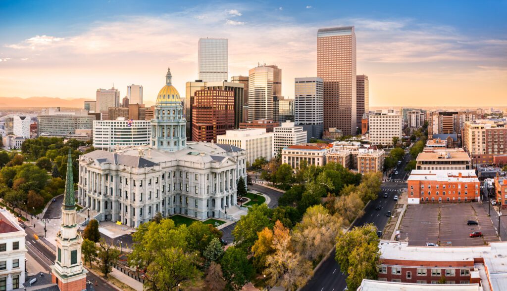 Denver skyline with Capitol building at sunset.